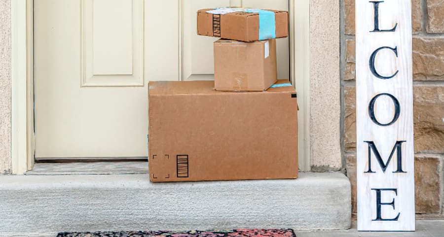 Packages on the doorstep of a home with a welcome sign in Bloomington